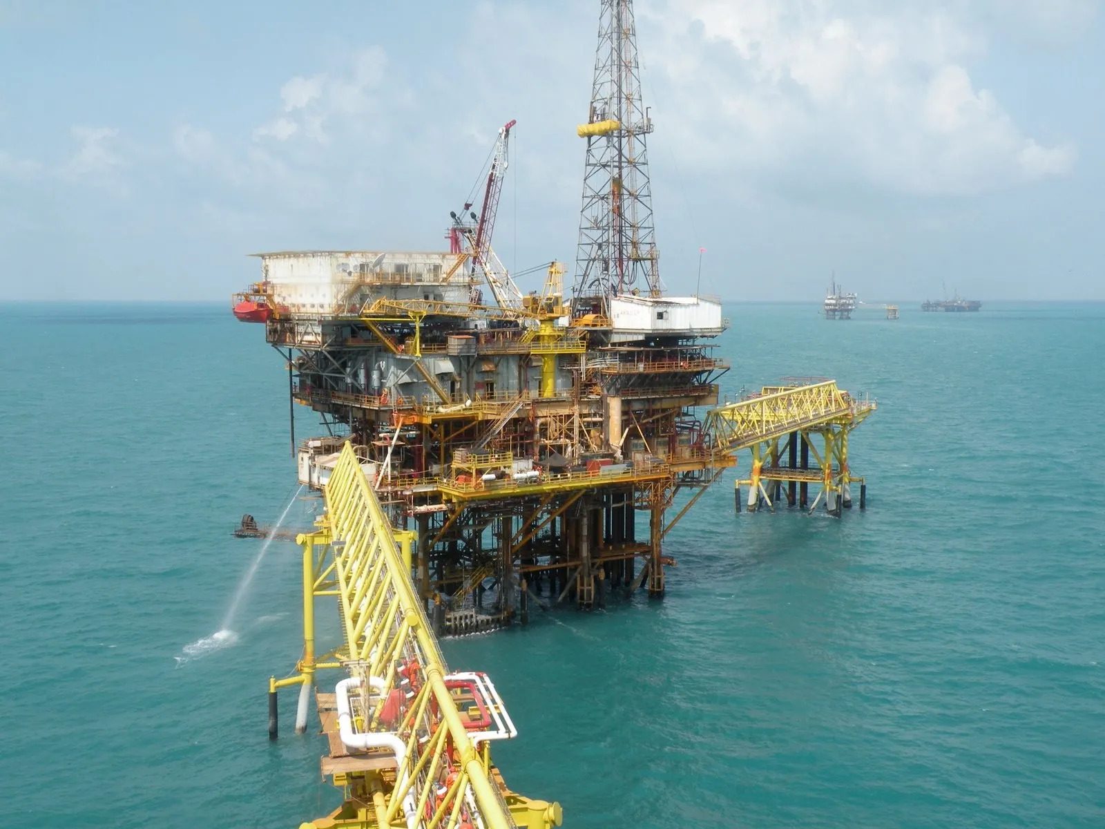 A large oil rig in the middle of an ocean.